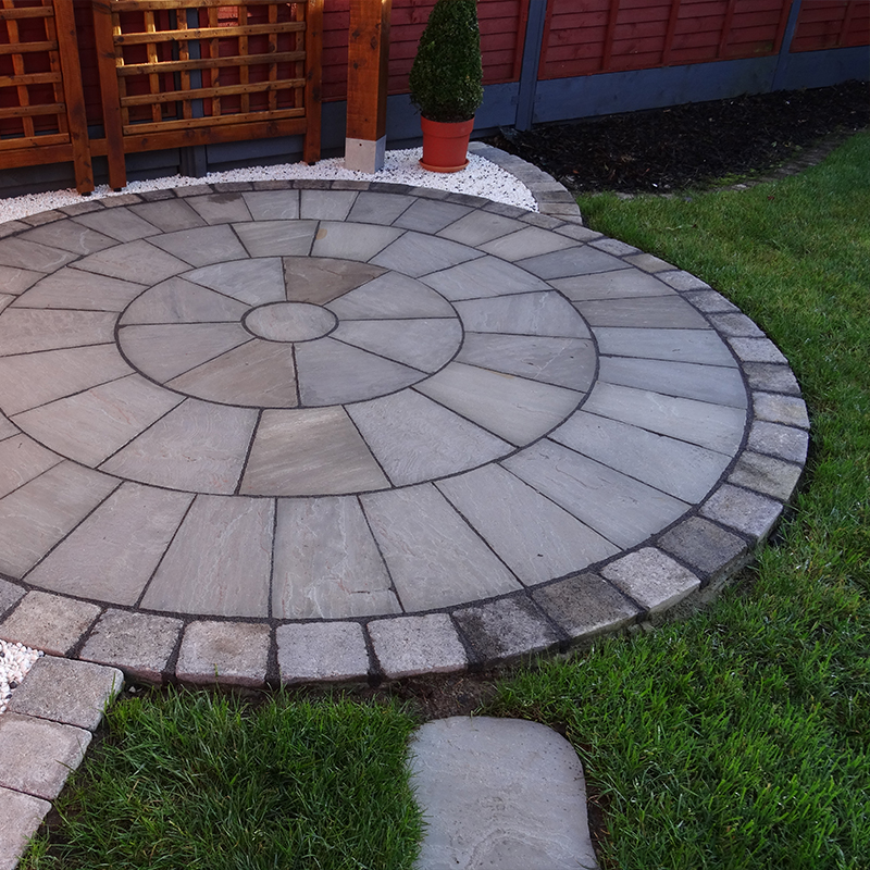 Kandla Grey Sandstone Circle pieces arranged on driveway